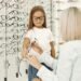 Child trying on glasses at an independent optician practice in the UK