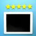 Five gold stars above a tablet on a blue background — Google review rating concept for UK independent optician practices.
