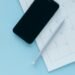 Smartphone resting on a paper calendar — illustrating online booking for UK independent opticians