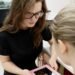 Optometrist consulting with a patient in a UK independent optician practice — clinical conversation about eye health