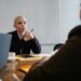 Two business professionals discussing strategy in a modern office — independent UK optician practice growth planning.