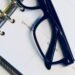 Eyeglasses resting on an open planner, illustrating optician appointment diary and scheduling
