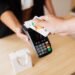 Close-up of contactless card payment on a modern POS terminal — UK optician practice management software payments and till integration.